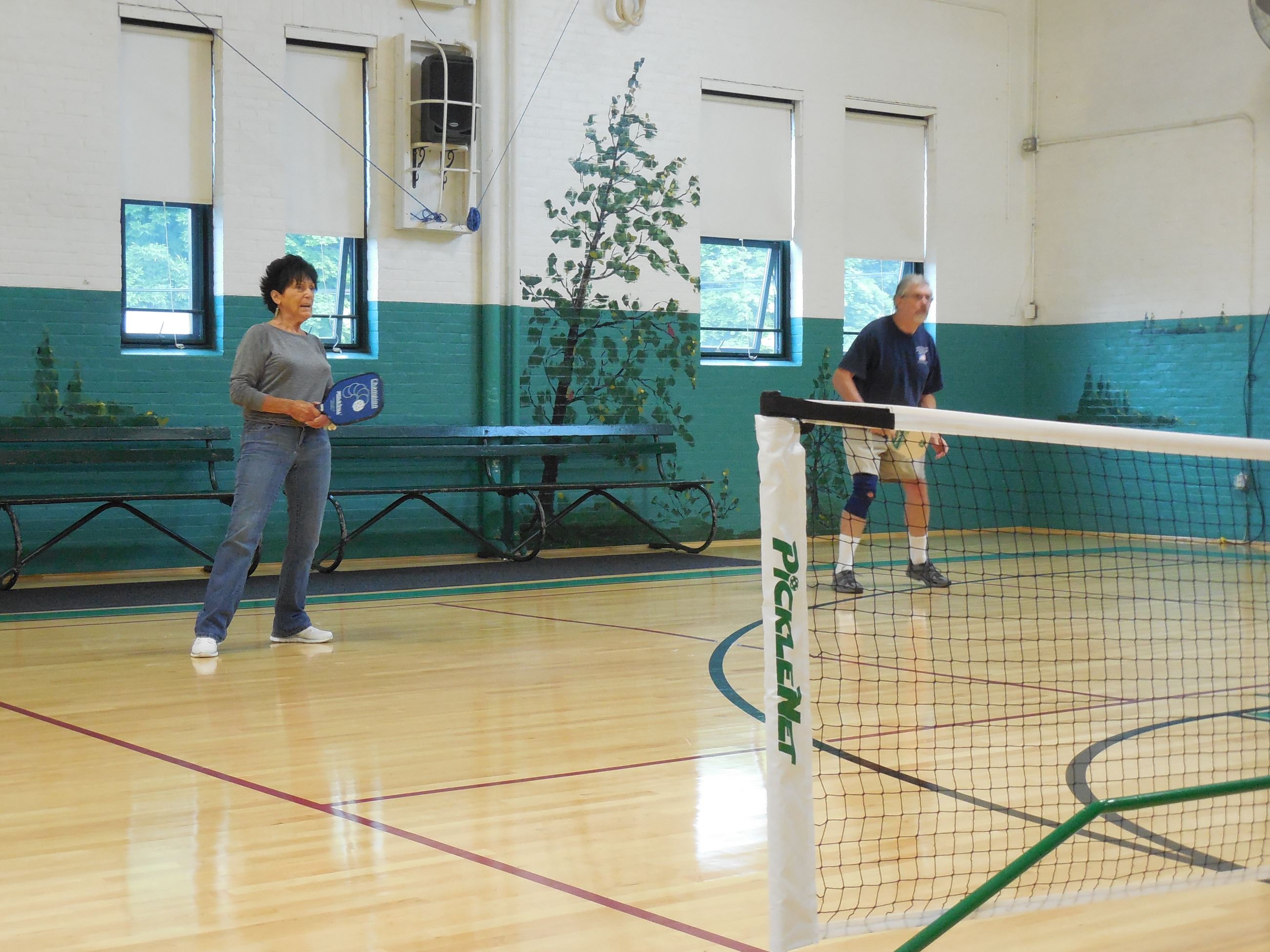 Two pickleball players waiting to return a serve